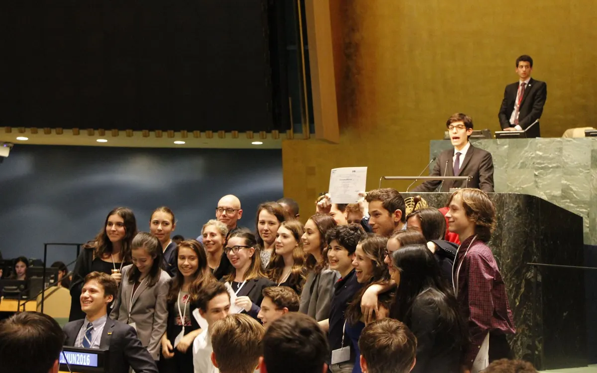 A student delegation celebrating as it accepts the Best Delegation award in the General Assembly Hall at UN Headquarters in New York