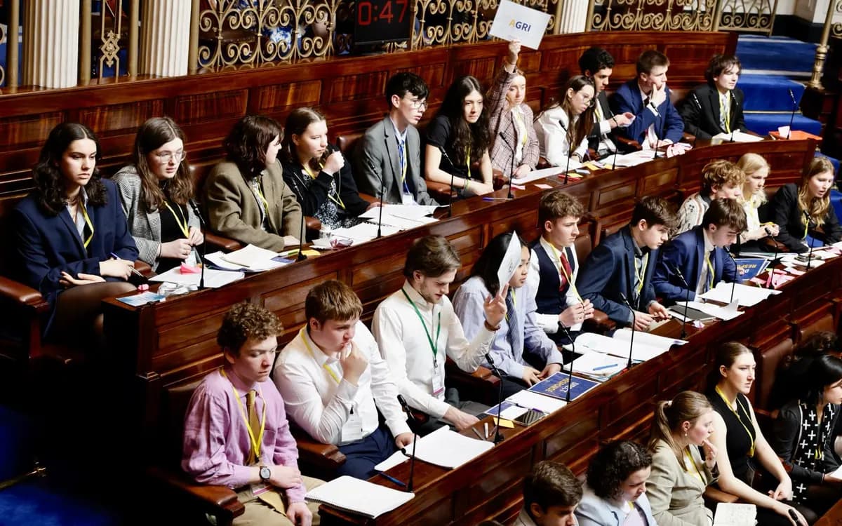 Student delegates seated along the benches of a debating chamber in Leinster House during European Youth Parliament Ireland